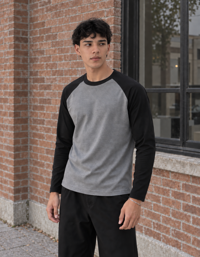 Fanaze Unisex Raglan T-Shirt in Black Charcoal Melange, charcoal melange body with black sleeves, worn by a model — three-quarter view.