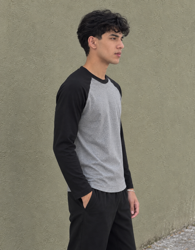 Fanaze Unisex Raglan T-Shirt in Black Charcoal Melange, charcoal melange body with black sleeves, worn by a model — side view.