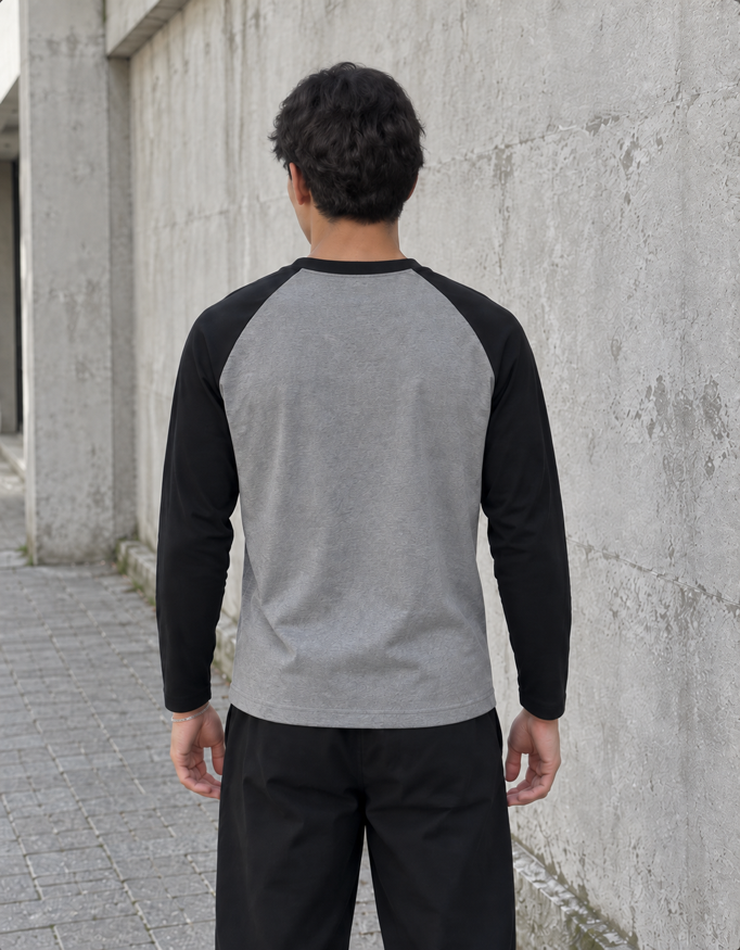 Fanaze Unisex Raglan T-Shirt in Black Charcoal Melange, charcoal melange body with black sleeves, worn by a model — back view.